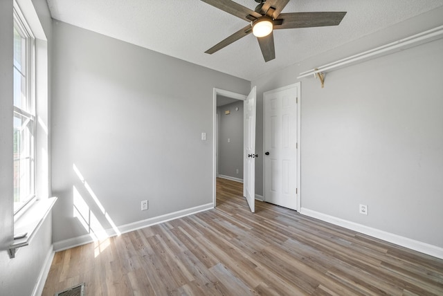 337 Atlantic Ave, Oak Grove, KY 42262 - unfurnished bedroom with wood finished floors, baseboards, a textured ceiling, and a ceiling fan