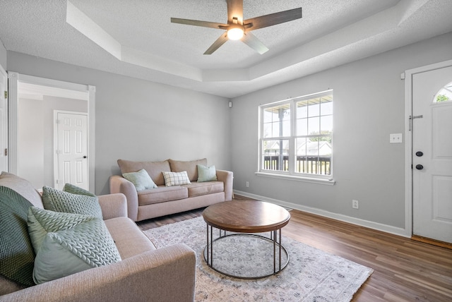 337 Atlantic Ave, Oak Grove, KY 42262 - living room featuring a tray ceiling, healthy amount of natural light, wood finished floors, a ceiling fan, and a textured ceiling