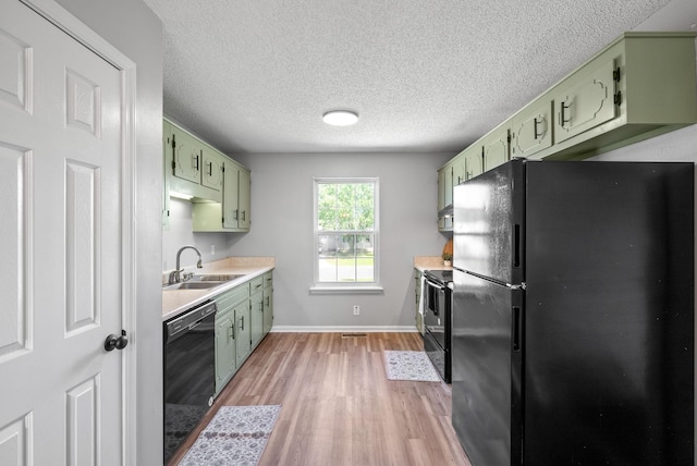 337 Atlantic Ave, Oak Grove, KY 42262 - kitchen featuring black appliances, green cabinetry, a sink, light countertops, and light wood-style flooring