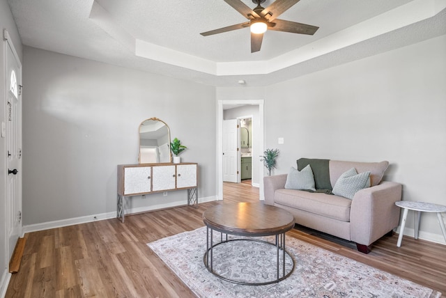 337 Atlantic Ave, Oak Grove, KY 42262 - living area with wood finished floors, ceiling fan, a raised ceiling, baseboards, and a textured ceiling