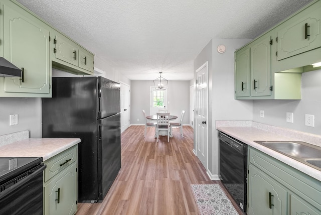 337 Atlantic Ave, Oak Grove, KY 42262 - kitchen with green cabinetry, black appliances, light countertops, light wood-type flooring, and a textured ceiling