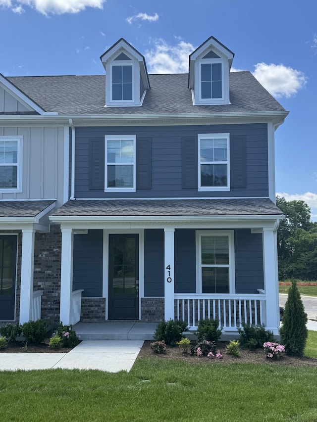 410 Blair Rd, Smyrna, TN 37167 - view of front facade featuring covered porch, board and batten siding, a front lawn, and roof with shingles