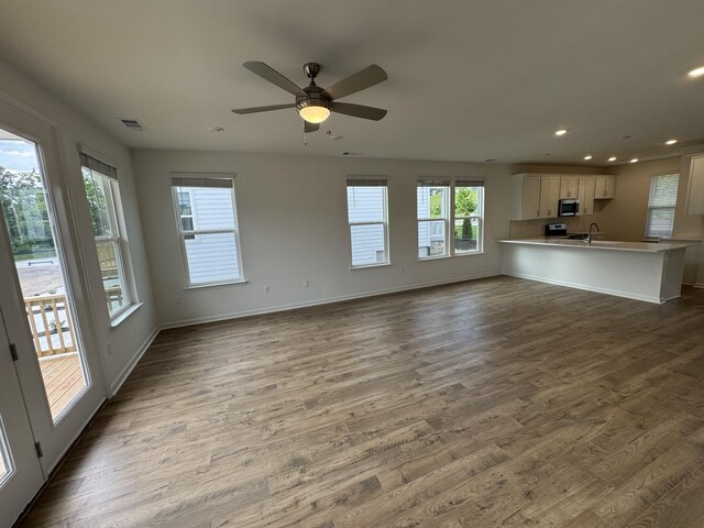 410 Blair Rd, Smyrna, TN 37167 - unfurnished living room featuring recessed lighting, wood finished floors, baseboards, a ceiling fan, and a sink