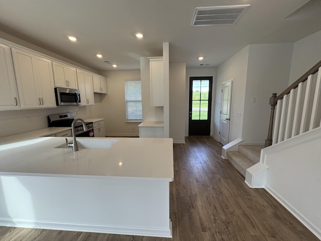 410 Blair Rd, Smyrna, TN 37167 - kitchen with appliances with stainless steel finishes, a peninsula, dark wood-type flooring, light countertops, and recessed lighting