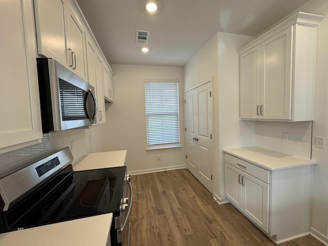 410 Blair Rd, Smyrna, TN 37167 - kitchen featuring appliances with stainless steel finishes, backsplash, dark wood-style flooring, white cabinets, and recessed lighting