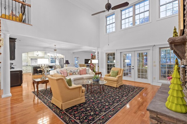 697 N Stewart Ln, Rising Fawn, GA 30738 - living area with ceiling fan, light wood finished floors, a towering ceiling, a chandelier, and french doors