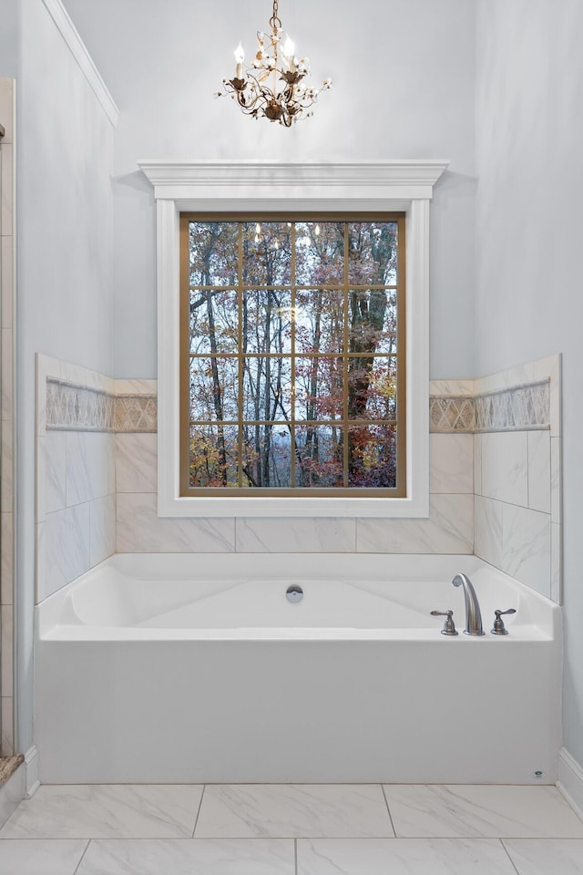 697 N Stewart Ln, Rising Fawn, GA 30738 - bathroom with marble look tiles, a chandelier, and a garden tub