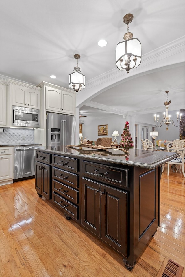 697 N Stewart Ln, Rising Fawn, GA 30738 - kitchen with appliances with stainless steel finishes, a chandelier, white cabinetry, dark brown cabinets, and arched walkways