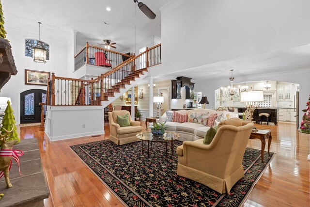 697 N Stewart Ln, Rising Fawn, GA 30738 - living area featuring a chandelier, crown molding, a high ceiling, stairway, and hardwood / wood-style flooring