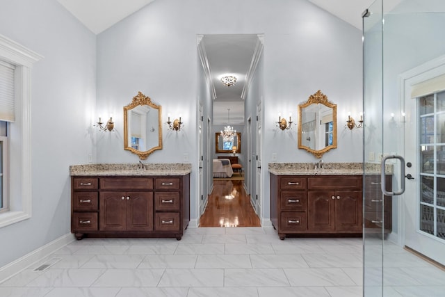 697 N Stewart Ln, Rising Fawn, GA 30738 - ensuite bathroom featuring high vaulted ceiling, marble look tile flooring, two vanities, and baseboards