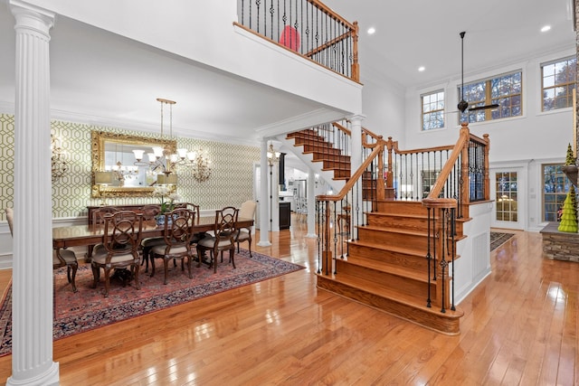 697 N Stewart Ln, Rising Fawn, GA 30738 - dining room with wallpapered walls, stairway, decorative columns, ornamental molding, and hardwood / wood-style floors