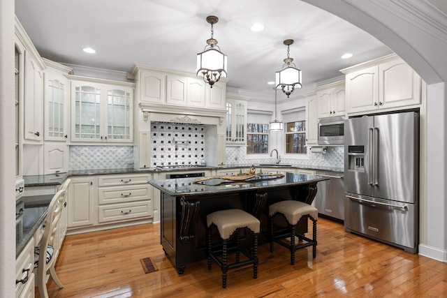 697 N Stewart Ln, Rising Fawn, GA 30738 - kitchen with appliances with stainless steel finishes, a sink, light wood-style flooring, a breakfast bar, and recessed lighting