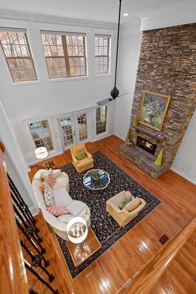 697 N Stewart Ln, Rising Fawn, GA 30738 - living room featuring wood finished floors, a fireplace, baseboards, crown molding, and ceiling fan