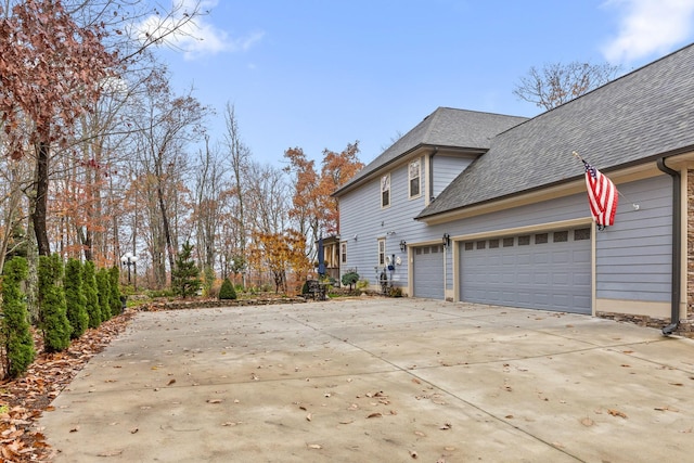 697 N Stewart Ln, Rising Fawn, GA 30738 - view of side of property featuring driveway, a shingled roof, and a garage