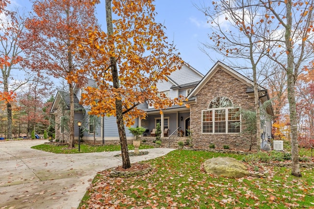 697 N Stewart Ln, Rising Fawn, GA 30738 - traditional-style house with stone siding, a porch, central AC unit, and a front lawn