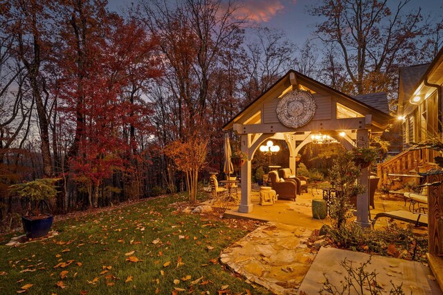 697 N Stewart Ln, Rising Fawn, GA 30738 - yard at dusk featuring a lawn, a patio, a gazebo, and an outdoor living space