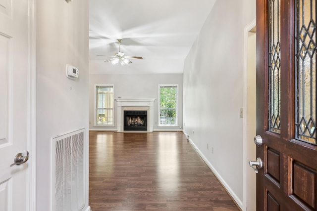 4348 Oakcrest Ln, Hermitage, TN 37076 - entrance foyer featuring ceiling fan, dark wood finished floors, a fireplace with flush hearth, and baseboards