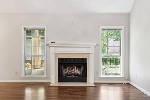 4348 Oakcrest Ln, Hermitage, TN 37076 - unfurnished living room with a fireplace with flush hearth, wood finished floors, and baseboards