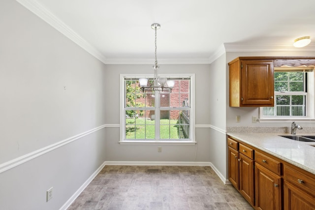 4348 Oakcrest Ln, Hermitage, TN 37076 - kitchen featuring healthy amount of natural light, a chandelier, a sink, brown cabinets, and crown molding