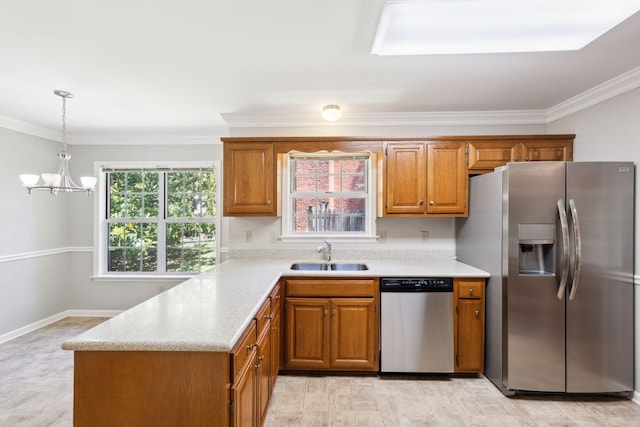 4348 Oakcrest Ln, Hermitage, TN 37076 - kitchen with stainless steel appliances, a sink, brown cabinetry, ornamental molding, and a chandelier