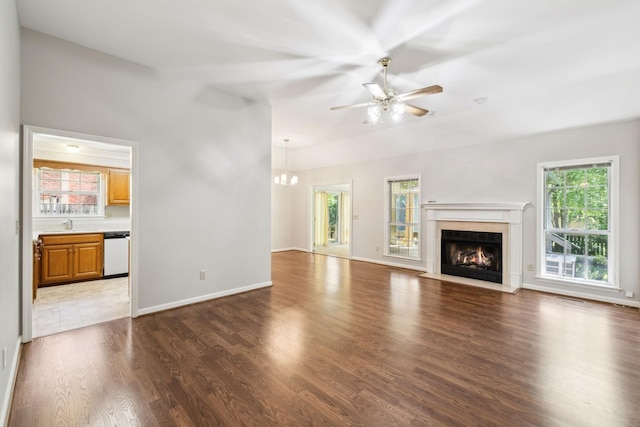 4348 Oakcrest Ln, Hermitage, TN 37076 - unfurnished living room with a fireplace with flush hearth, wood finished floors, ceiling fan, a chandelier, and baseboards