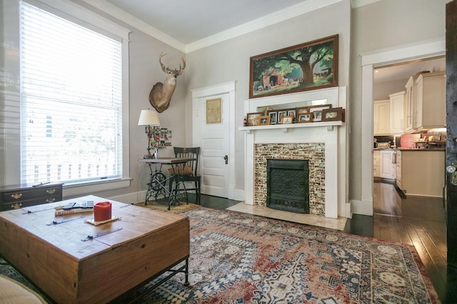 712 W Main St, Franklin, TN 37064 - living area with wood-type flooring, a tiled fireplace, crown molding, and baseboards
