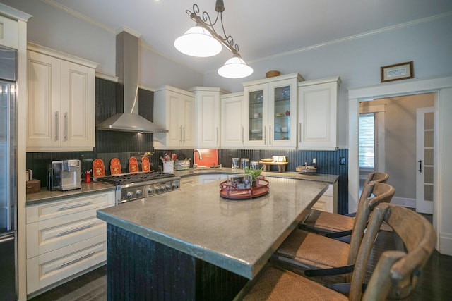 712 W Main St, Franklin, TN 37064 - kitchen featuring range hood, tasteful backsplash, ornamental molding, a breakfast bar, and a sink