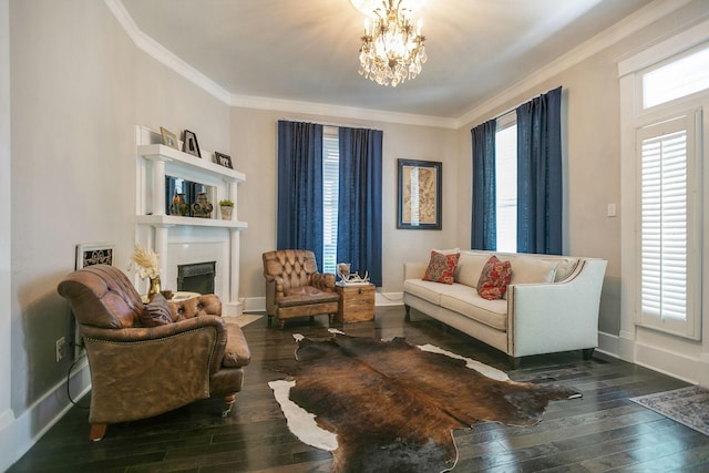 712 W Main St, Franklin, TN 37064 - living room featuring dark wood-style flooring, crown molding, a fireplace, baseboards, and a chandelier