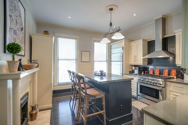 712 W Main St, Franklin, TN 37064 - kitchen featuring premium appliances, crown molding, wall chimney range hood, a kitchen island, and backsplash