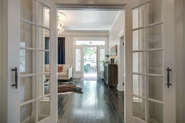 712 W Main St, Franklin, TN 37064 - foyer entrance with french doors, ornamental molding, dark wood-style flooring, and a chandelier