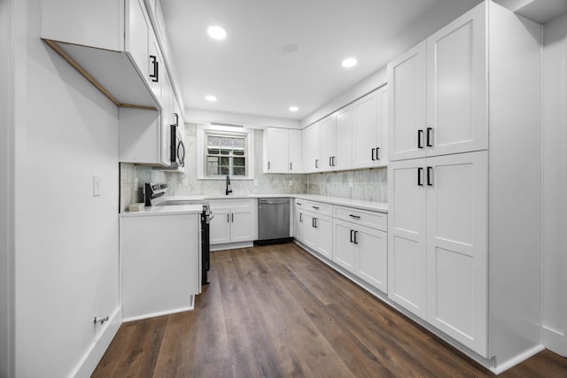 176 Kirby Dr, Clarksville, TN 37042 - kitchen with stainless steel appliances, a sink, dark wood-style flooring, tasteful backsplash, and white cabinetry