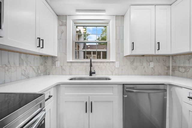 176 Kirby Dr, Clarksville, TN 37042 - kitchen with stainless steel dishwasher, a sink, tasteful backsplash, and white cabinetry