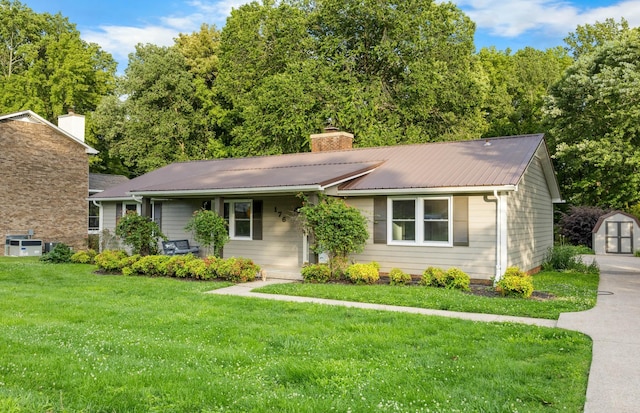 176 Kirby Dr, Clarksville, TN 37042 - view of front of home with a front lawn, a chimney, metal roof, a porch, and central AC unit