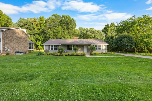 176 Kirby Dr, Clarksville, TN 37042 - view of front of home featuring a chimney, a front yard, and metal roof