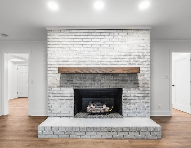 176 Kirby Dr, Clarksville, TN 37042 - detailed view of crown molding, a brick fireplace, recessed lighting, baseboards, and wood finished floors