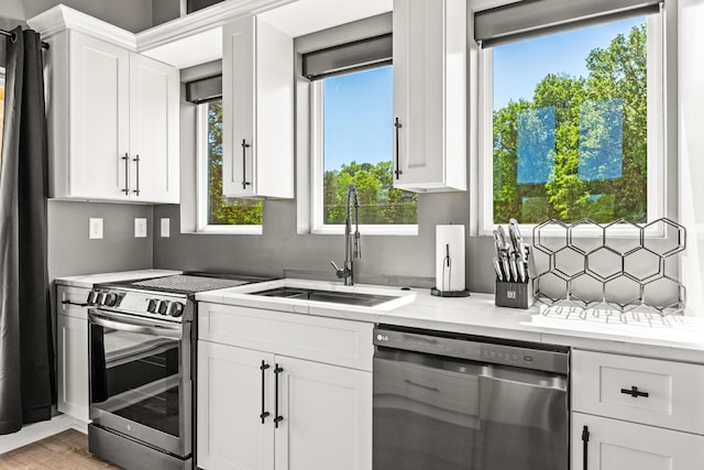 14 Lewter Rd, Taft, TN 38488 - kitchen with appliances with stainless steel finishes, a sink, white cabinetry, and light stone countertops