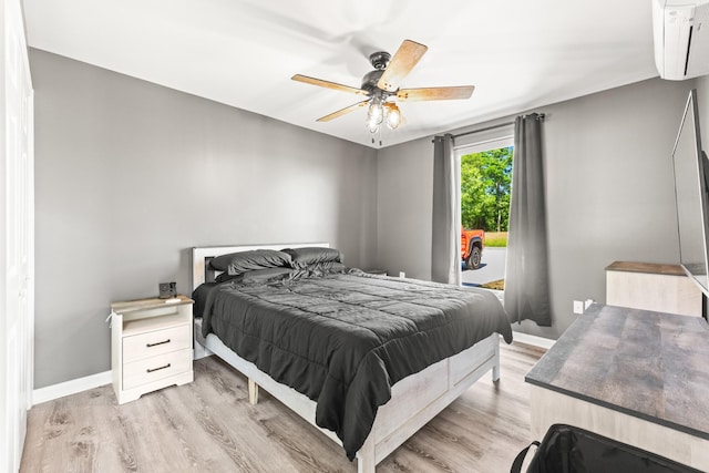 14 Lewter Rd, Taft, TN 38488 - bedroom featuring light wood-type flooring, a wall unit AC, baseboards, and a ceiling fan