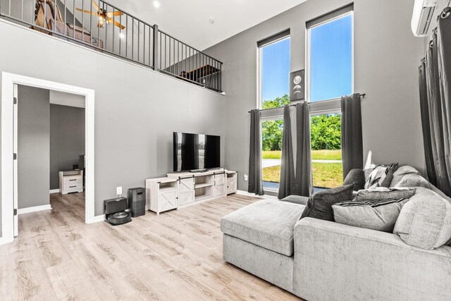 14 Lewter Rd, Taft, TN 38488 - living area with a towering ceiling, wood finished floors, baseboards, and a wall mounted air conditioner