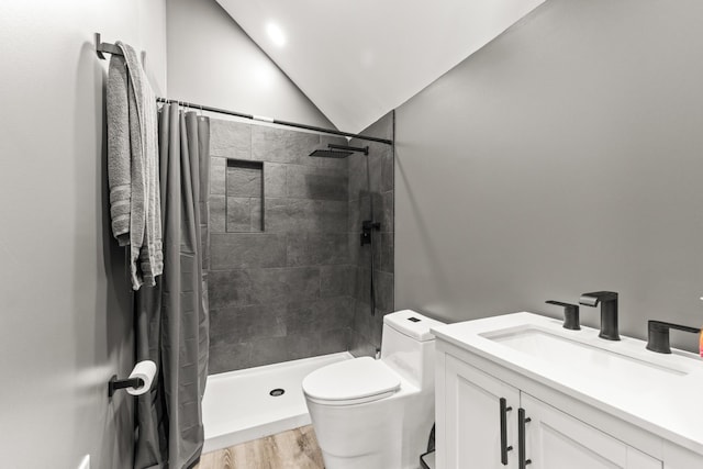 14 Lewter Rd, Taft, TN 38488 - full bath with toilet, tiled shower, wood finished floors, vanity, and vaulted ceiling