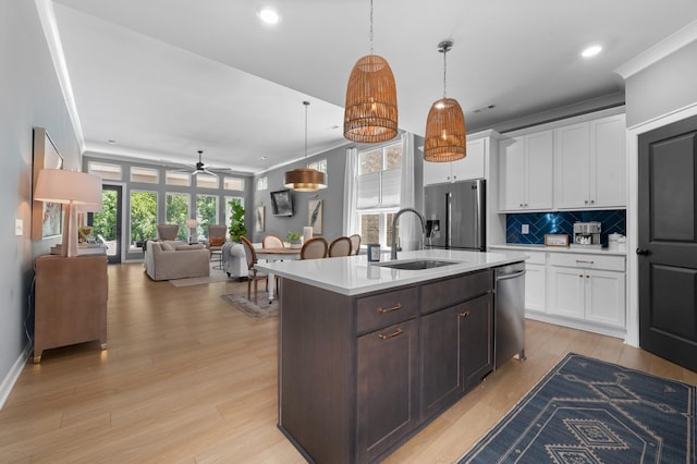 894 Plowson Rd, Mount Juliet, TN 37122 - kitchen featuring stainless steel appliances, a sink, light countertops, white cabinetry, and backsplash