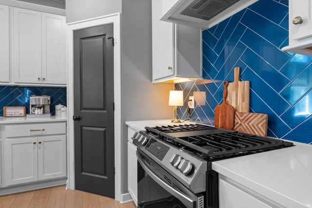 894 Plowson Rd, Mount Juliet, TN 37122 - kitchen featuring stainless steel gas range, decorative backsplash, light countertops, and white cabinets