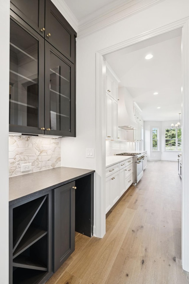 1001 Laguna Dr, Franklin, TN 37067 - bar featuring premium range hood, light wood-type flooring, ornamental molding, tasteful backsplash, and recessed lighting