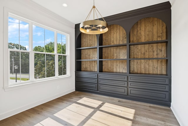 1001 Laguna Dr, Franklin, TN 37067 - spare room featuring wood finished floors, crown molding, and a chandelier