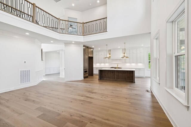 1001 Laguna Dr, Franklin, TN 37067 - unfurnished living room featuring a high ceiling, light wood-type flooring, and recessed lighting