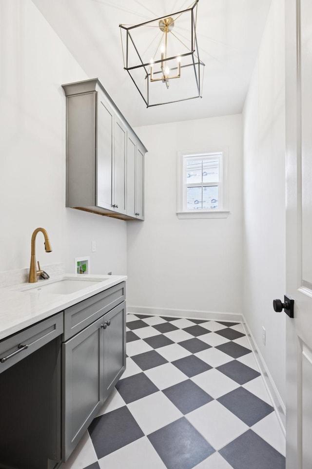 1001 Laguna Dr, Franklin, TN 37067 - laundry room featuring hookup for a washing machine, light floors, cabinet space, and a chandelier