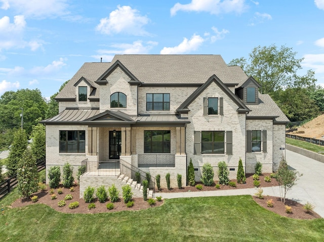 1001 Laguna Dr, Franklin, TN 37067 - french provincial home featuring covered porch, brick siding, a standing seam roof, and roof with shingles