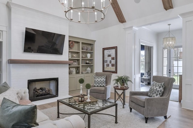 9906 Amarosa Ct, Brentwood, TN 37027 - living area featuring a chandelier, light wood finished floors, a fireplace, and decorative columns