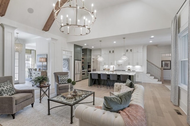 9906 Amarosa Ct, Brentwood, TN 37027 - living area with a chandelier, high vaulted ceiling, light wood-style flooring, and stairs