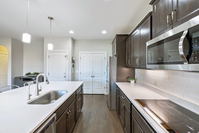 743 Burgess Dr, Goodlettsville, TN 37072 - kitchen featuring stainless steel appliances, a sink, dark wood finished floors, dark brown cabinetry, and light countertops