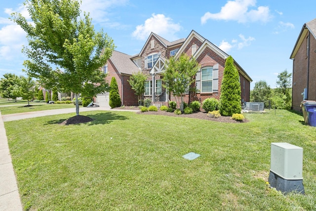 743 Burgess Dr, Goodlettsville, TN 37072 - view of front facade with brick siding, a front lawn, an attached garage, and central AC